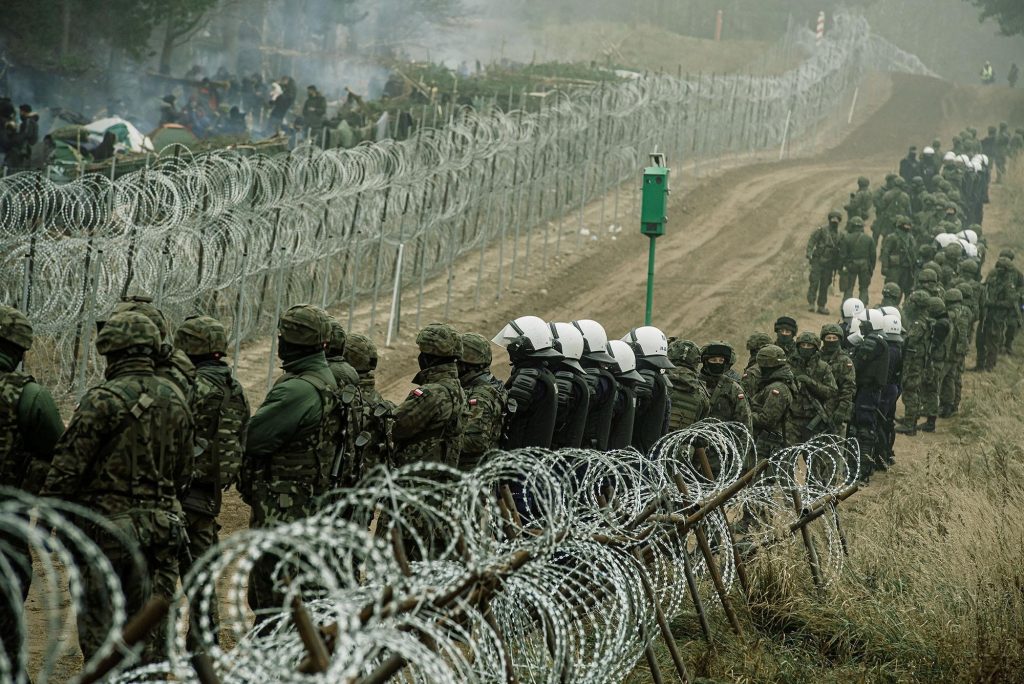 Dozens of migrants breach the fence separating Poland and Belarus