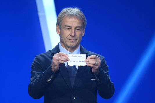 Jurgen Klinsmann with the Netherlands national team's ticket for the Euro 2024 qualifying draw in Germany.