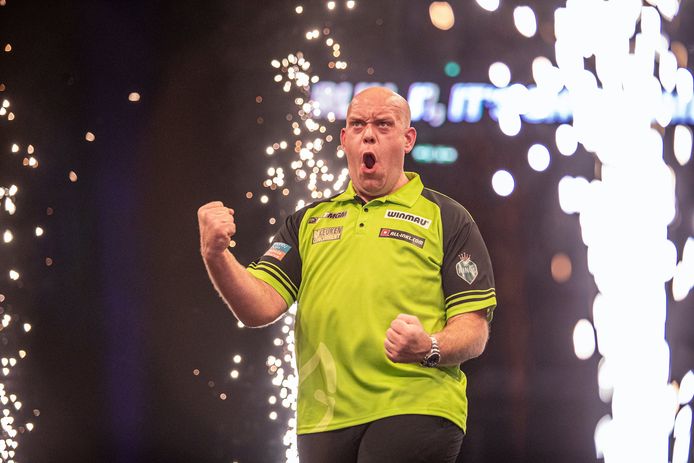 Michael van Gerwen clenches his fists after beating Littler.