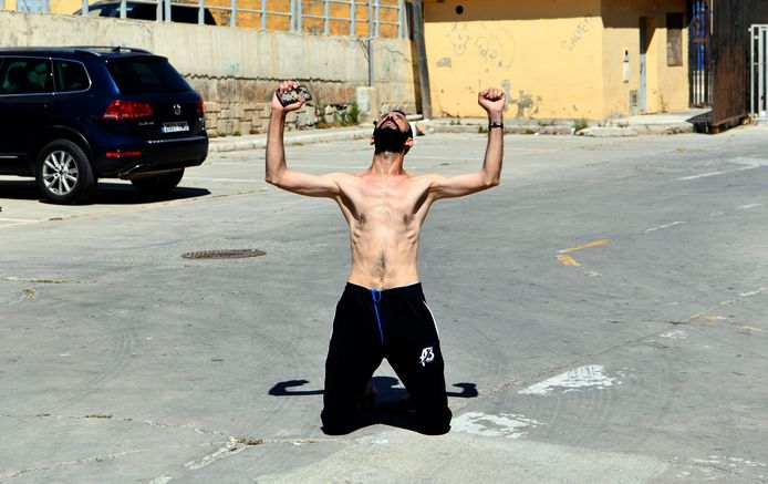 A man tightens his fists after entering Spain while swimming.