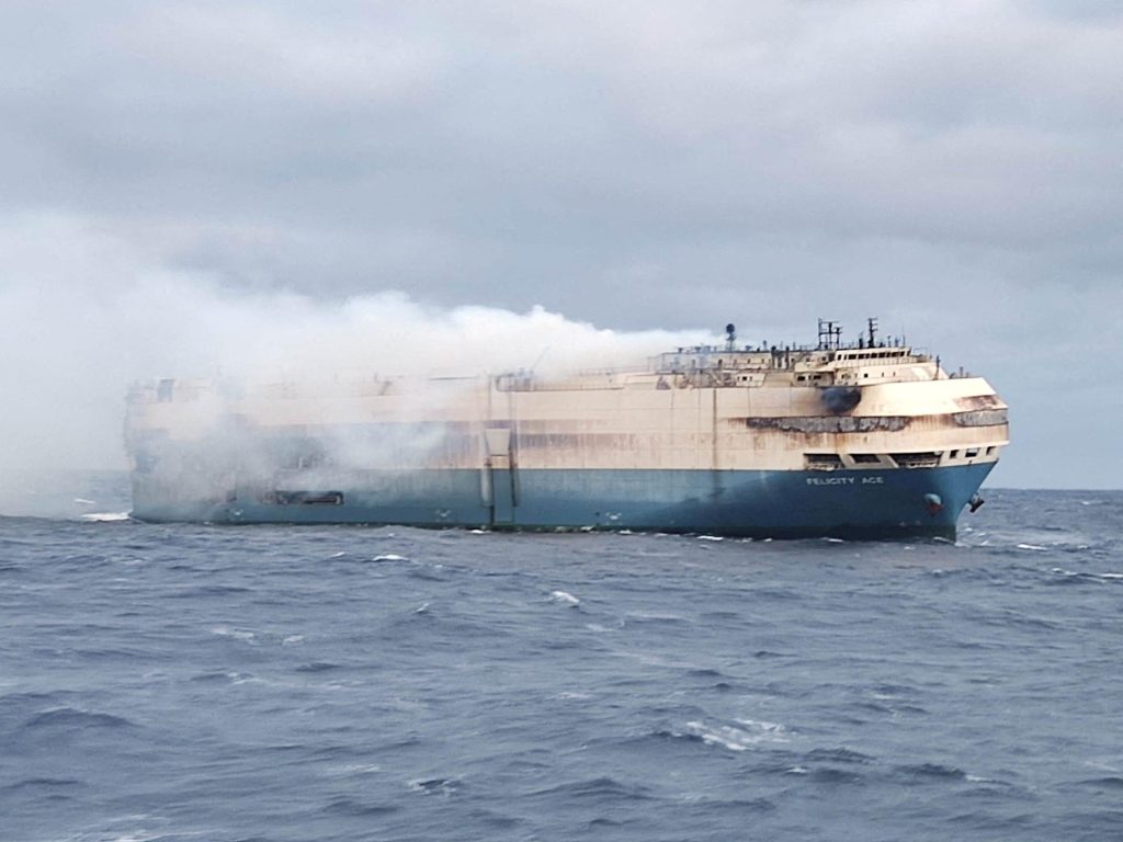 A burning ship containing 1,100 Porsches and 189 Bentleys sank